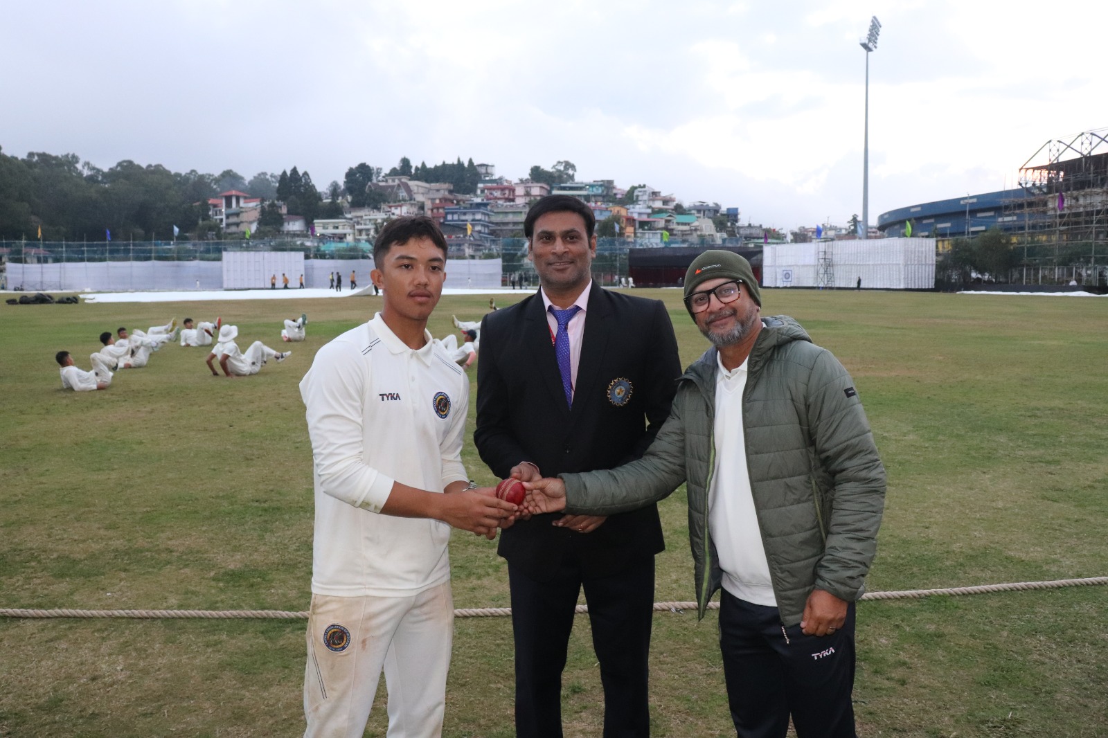 Mizoram's Johan (left) is presented with the ball he bowled with to take figures of 7 for 54