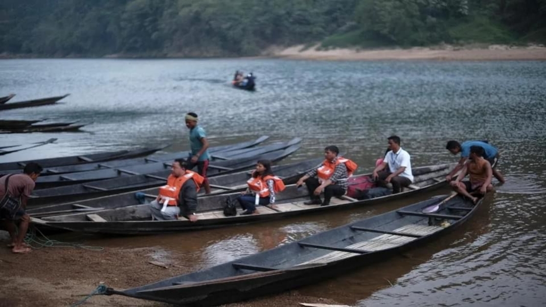 Polling officers cross the Myntdu River by boats to ensure voting access for voters at Kamsing Polling Station