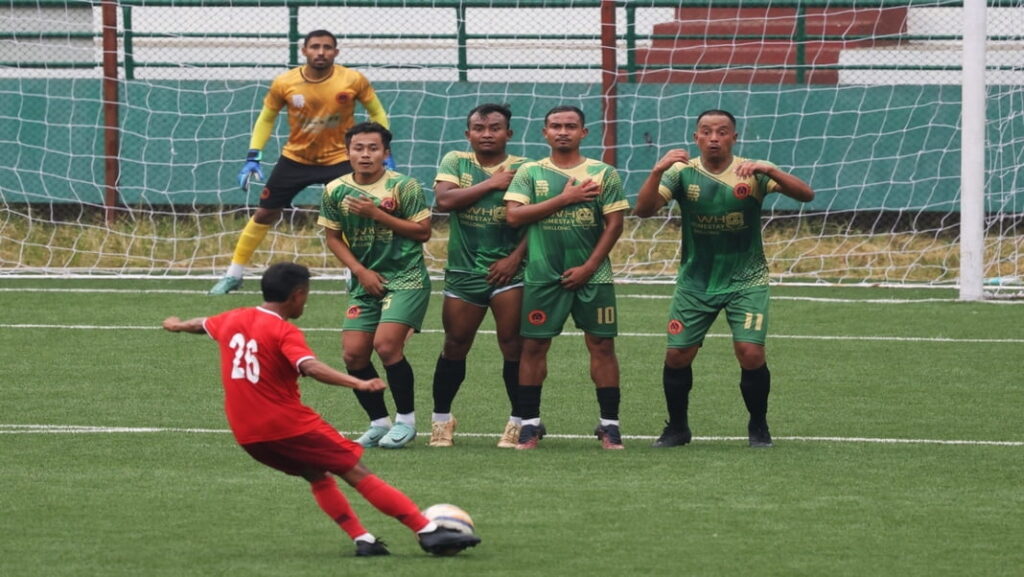 Sawmer in red, Nangkiew Irat in green, Nangkiew Irat's goalkeeper in yellow/black