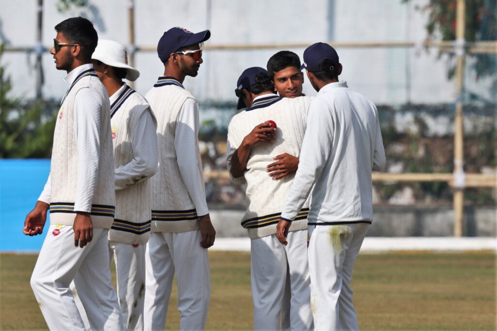 Delhi's Udhav Mohan (second right) celebrates taking the last wicket