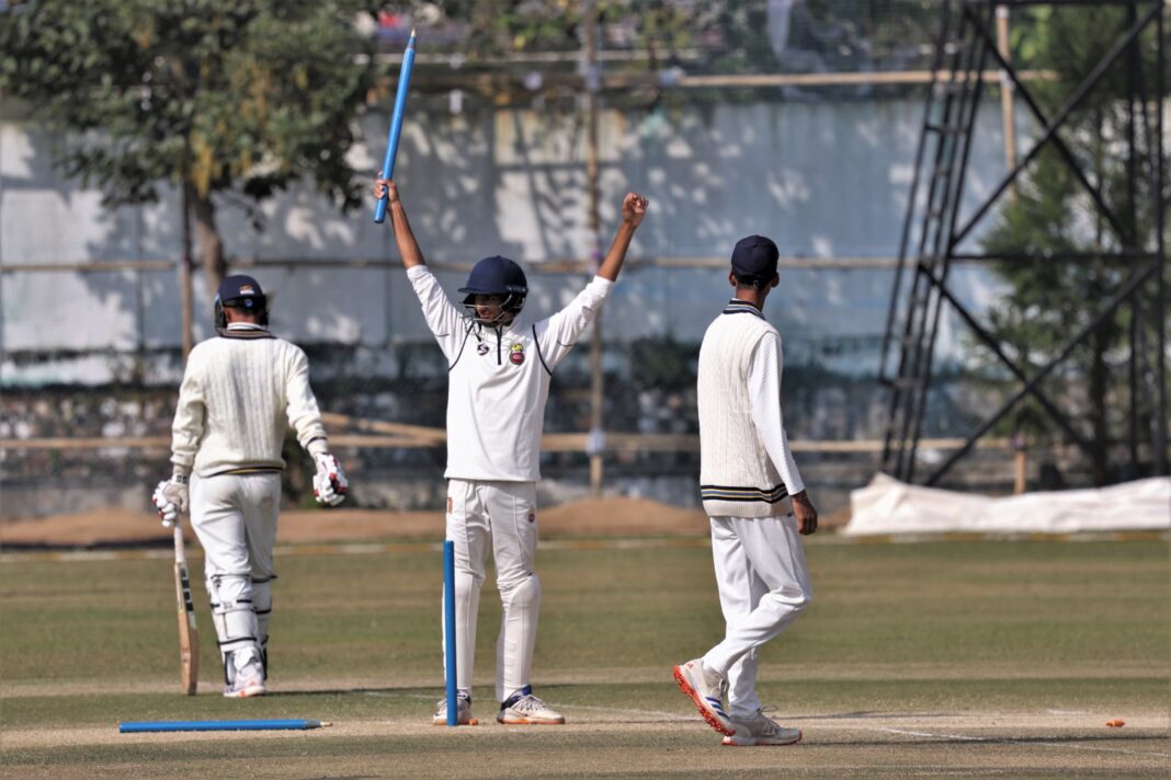 Delhi's Udhav Mohan (second right) celebrates taking the last wicket